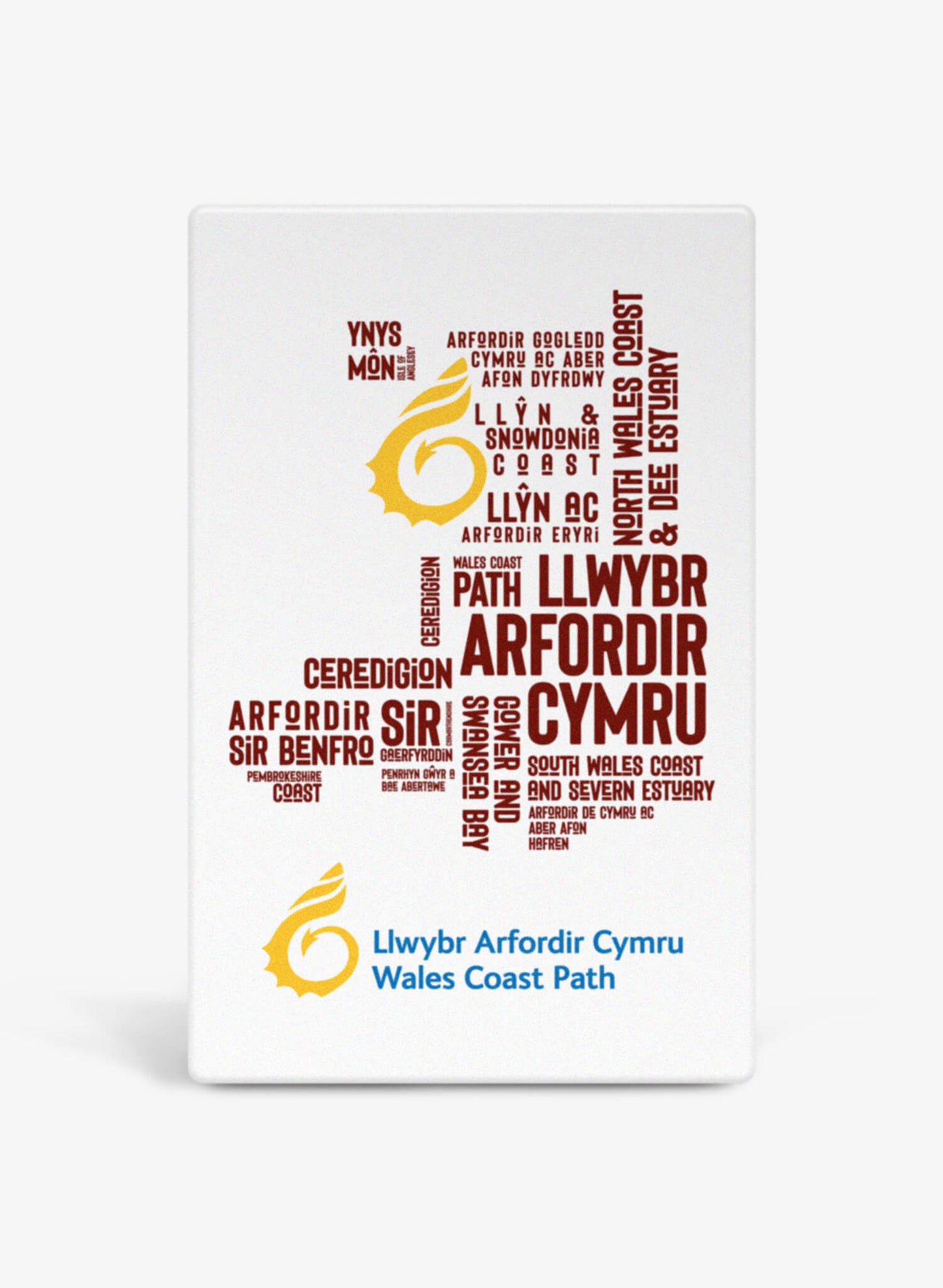 White ceramic fridge magnet featuring place names from the Wales Coast Path.