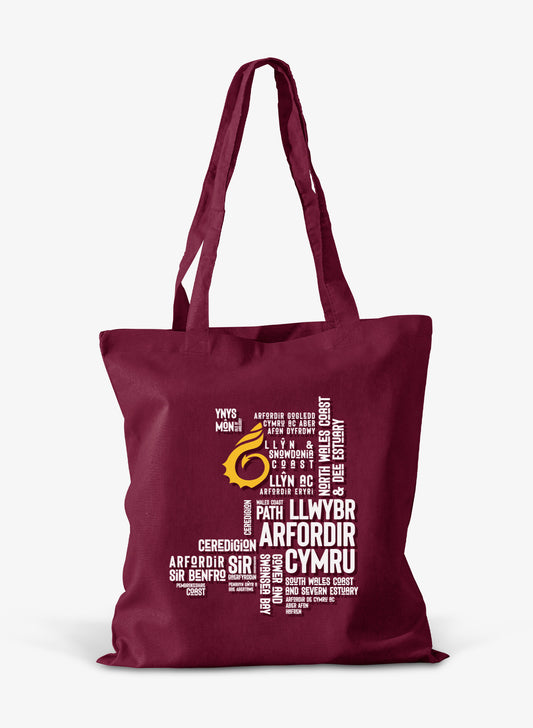 Burgundy cotton shoper bag featuring place names from the Wales Coast Path