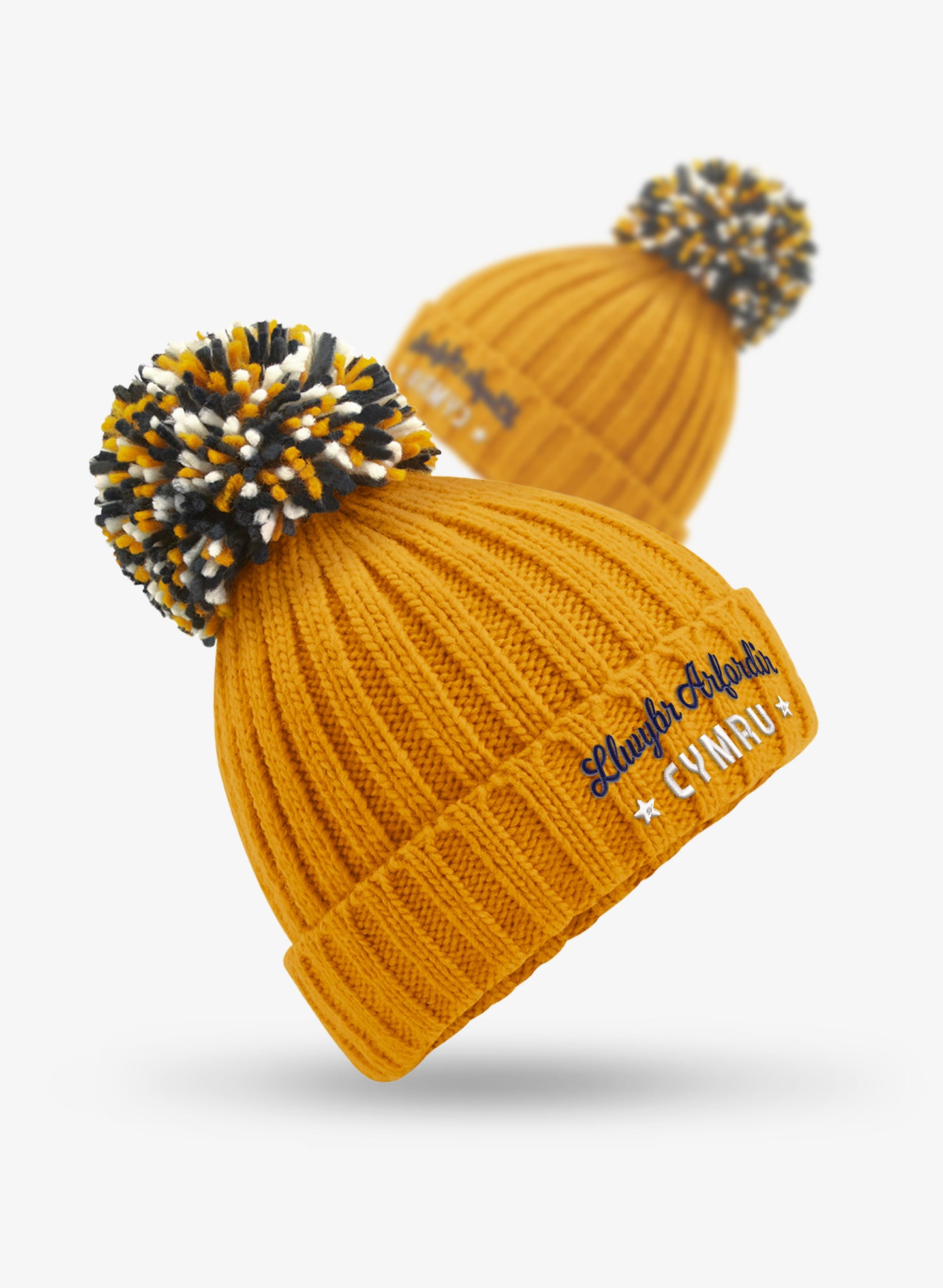 Welsh embroidered mustard yellow Wales Coast Path chunky knitted beanie with cuffed design and multi-coloured pom pom.